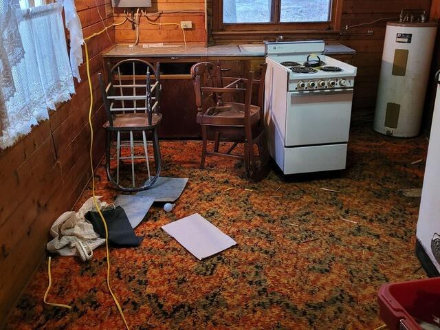 Concrete Slab Under Log Cabin Lifted and Leveled in Cedar River, MI - Before Photo