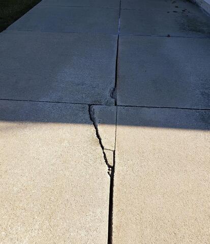 Cracked, Sloping Concrete Driveway Causing Foundation Water Issues Fixed in Mount Calvary, WI - Before Photo