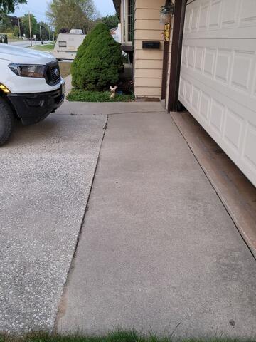 Sinking Driveway & Garage Apron Lifted and Joints Sealed in Whitelaw, WI - Before Photo
