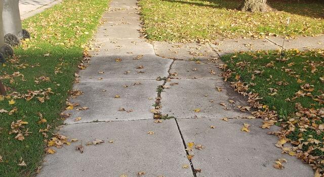 Cracked and Sunken Concrete Driveway Repaired in Lomira, WI - Before Photo