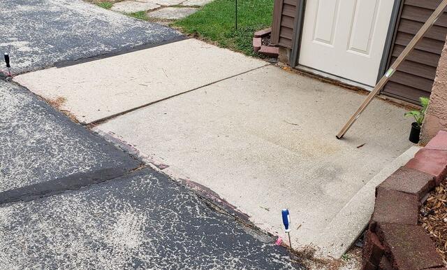 Sunken Concrete Pad Lifted with Polylevel Foam in Lomira, WI - Before Photo