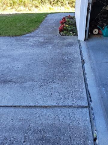 Unlevel Concrete Garage Apron Lifted & Joints Sealed in Sheboygan, WI - Before Photo