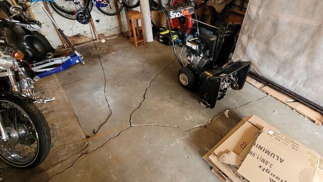 Cracked Garage Floor Concrete Leveling & Repair in Green Bay, WI - Before Photo