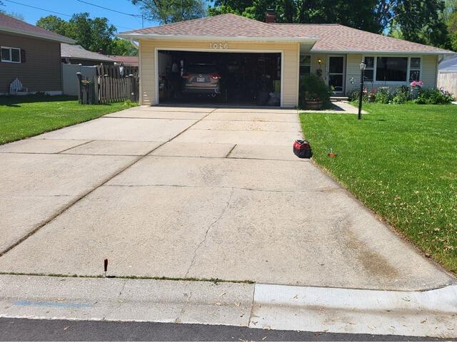 Uneven Sidewalk Leveled & Joints Sealed Using PolyLevel Foam  in Green Bay, WI - Before Photo
