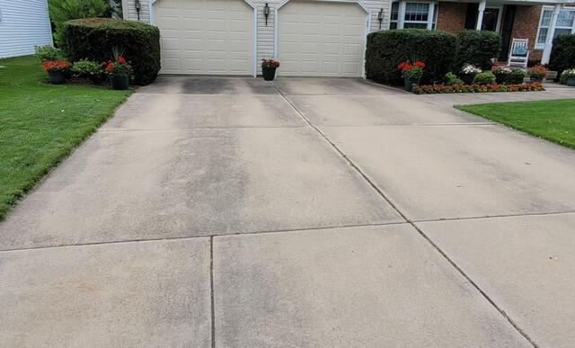 Sunken Concrete Driveway Lifted and Leveled in Green Bay, WI - Before Photo