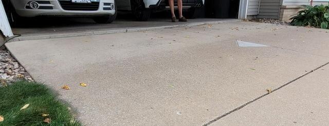 Sinking Concrete Garage Apron Repaired in Oshkosh, WI - Before Photo