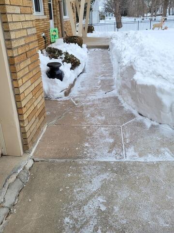 Concrete Driveway Sinking and Cracking Repaired in Oshkosh, WI - Before Photo
