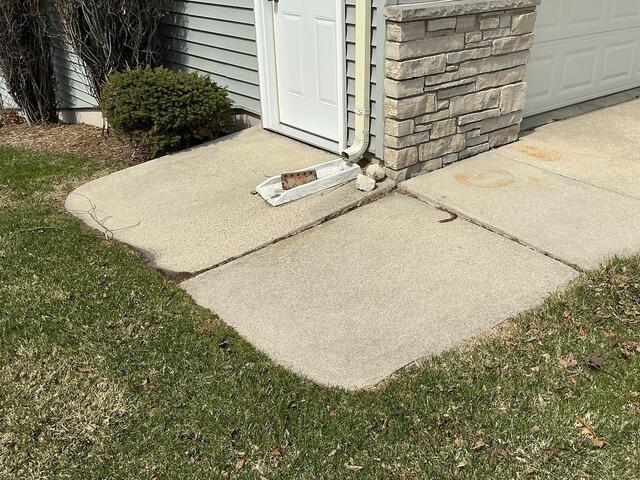 Failing Concrete Driveway Lifted and Leveled in Fond Du Lac, WI - Before Photo