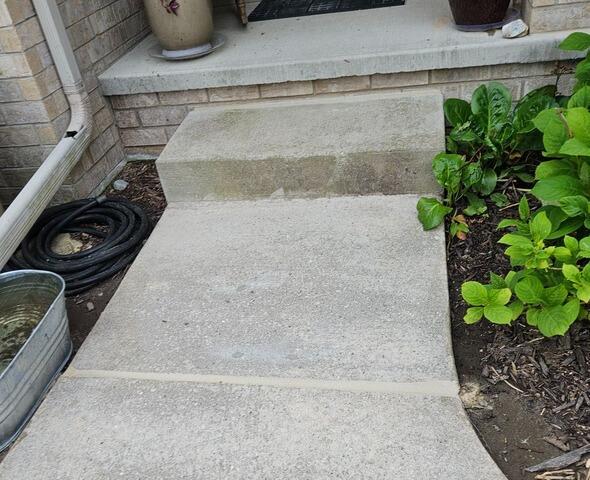 Sinking Concrete Driveway Lifted, Repaired & Sealed in Sturgeon Bay, WI - After Photo