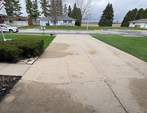 Failing Concrete Driveway Lifting, Sealing & Repair in Juneau, WI - Before Photo
