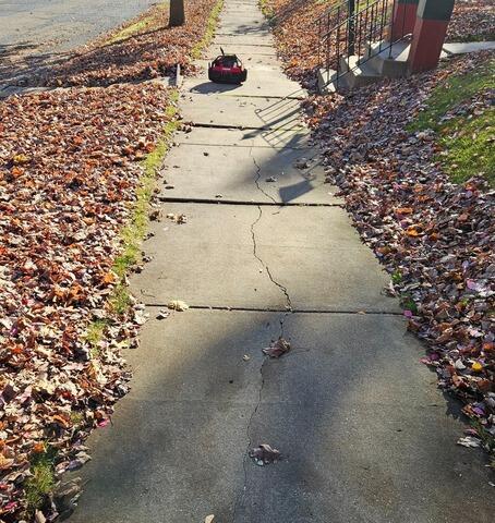 Cracked and Sunken Sidewalk Repair in Marshfield, WI - Before Photo