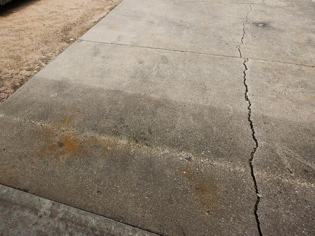 Sunken and Cracked Concrete Repaired & Cracks Sealed in Plover, WI - Before Photo