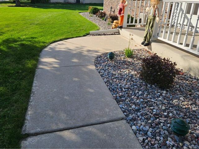 Cracked and Sunken Concrete Sidewalk Repaired in Antigo, WI - Before Photo