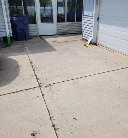 Cracked Concrete Driveway Repaired with PolyLevel Foam in Port Washington, WI - Before Photo