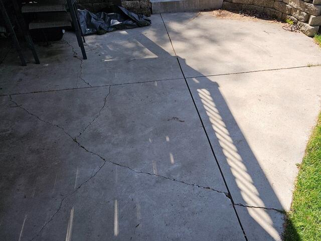 Sunken Cement Driveway Lifting & Repair in Menominee, MI - Before Photo