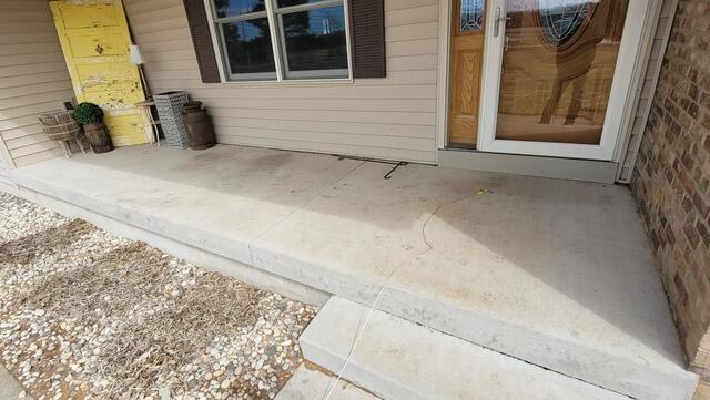 Sunken Concrete Patio Lifted in Menominee, MI - Before Photo