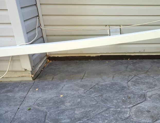 Uneven Stamped Concrete Patio Lifted & Joints Sealed in Kimberly, WI - Before Photo