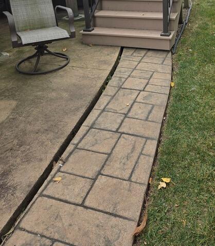 Stamped Concrete Patio Border Lifted with Foam in Kimberly, WI - Before Photo