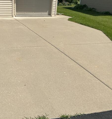 Sunken Concrete Driveway Leveling, Repair & Sealing in Menasha, WI - Before Photo