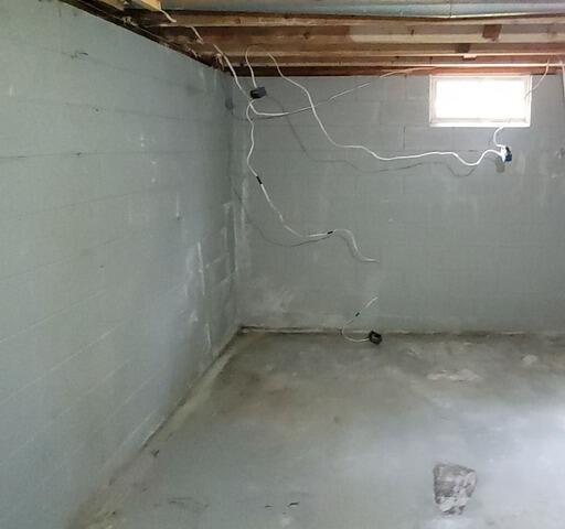 Drainage & Battery Back-up Sump Pump System Solves Basement Water Issues in Kingsford, MI - Before Photo