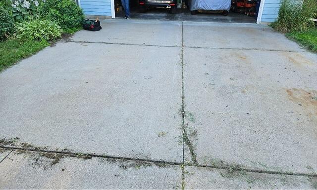 Settling, Uneven Concrete Driveway  Lifted, Repaired & Sealed in Wausau, WI - Before Photo