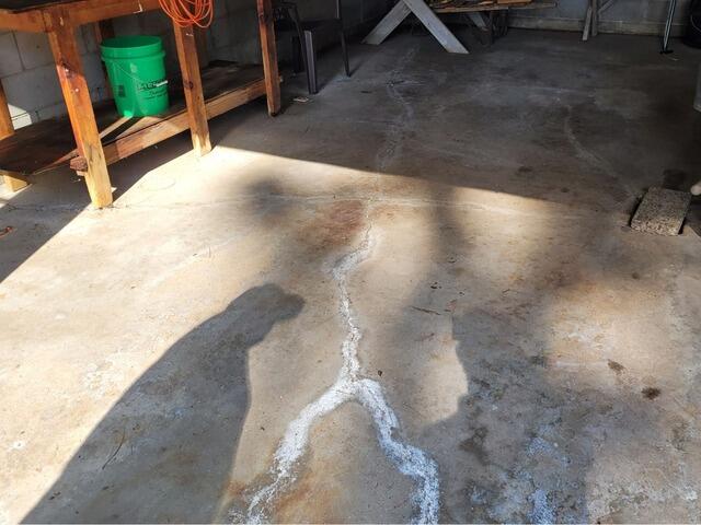 Cracked Concrete Garage Floor Repaired & Sealed in Minocqua, WI - Before Photo