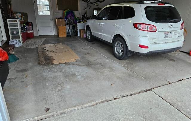 Garage Floor Concrete Leveling and Crack Repair in Green Bay, WI - Before Photo