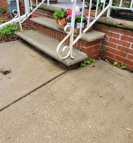 Concrete Driveway Leveling and Crack Repair in Green Bay, WI - Before Photo
