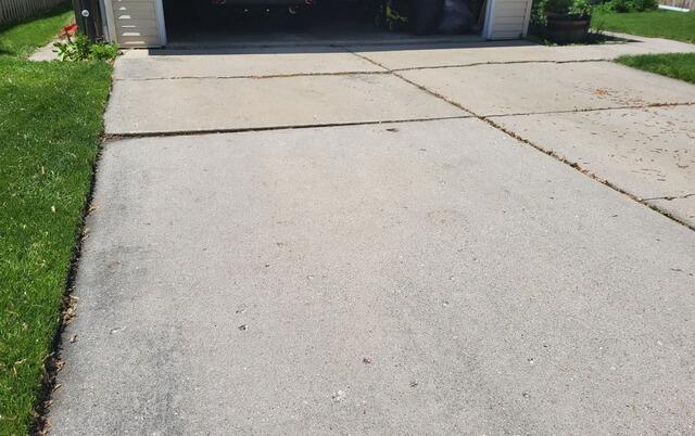 Badly Cracked and Sunken Concrete Driveway Repair in Green Bay, WI - Before Photo