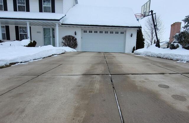 Sunken Driveway and Front Walkway Repaired in De Pere, WI - Before Photo