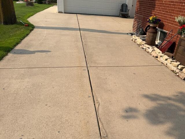 Sunken Driveway and Entrance Concrete Repaired in Denmark, WI - Before Photo