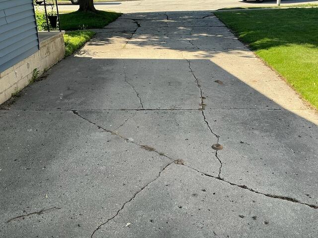 Badly Cracked and Uneven Driveway Repaired in Denmark, WI - Before Photo
