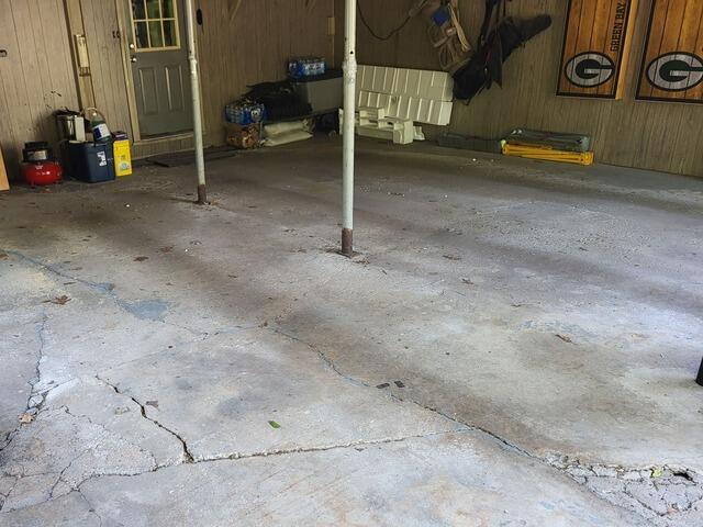 Badly Cracked and Uneven Garage Floor Repaired in Oneida, WI - Before Photo