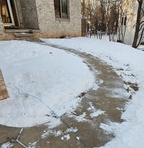Uneven Concrete Driveway and Front Walkway Repaired in Wrightstown, WI - Before Photo