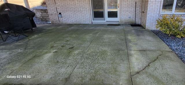 Sunken Concrete Patio Beneath Second-Story Deck Repaired in Wrightstown, WI - Before Photo