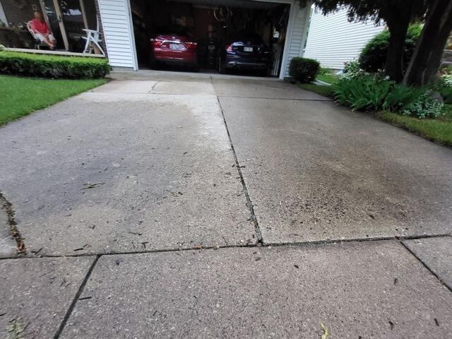 Sunken and Cracked Driveway and Front Walkway Repaired in Appleton, WI - Before Photo