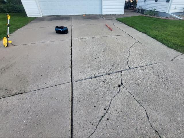 Sunken and Cracked Concrete Driveway and Walkway Repair in Black Creek, WI - Before Photo