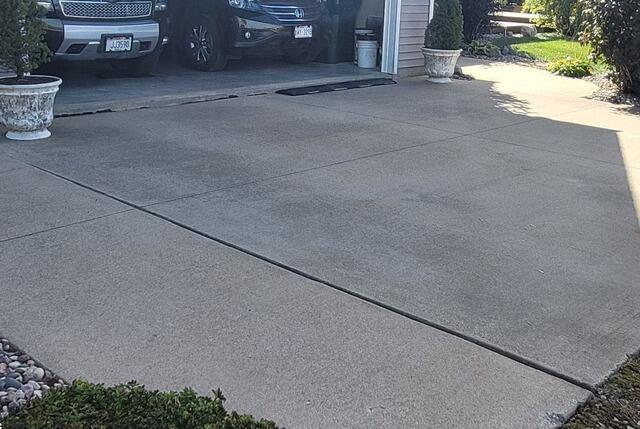 Sunken Driveway and Cracked Sidewalk Lifted and Repaired in Hortonville, WI - Before Photo