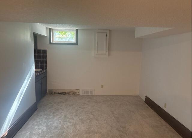 Tilting Foundation Wall Stabilized in Maple Grove, MN - Before Photo
