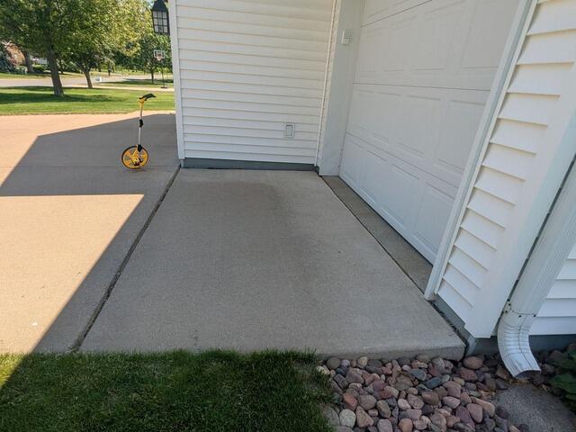 Sunken Driveway Leveling in Eau Claire, WI - Before Photo