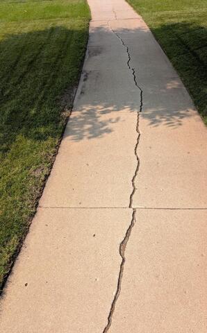 Cracked Sidewalk Repaired in Grand Forks, ND - Before Photo