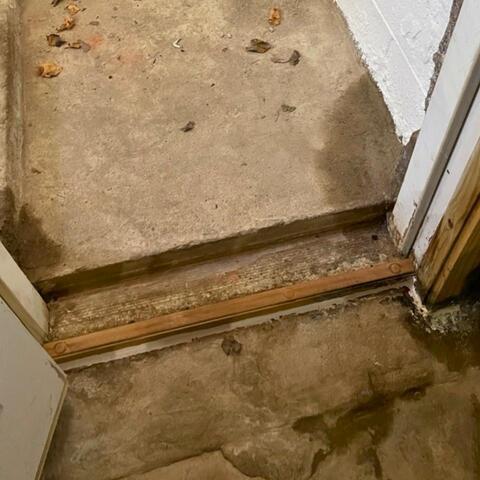 Drainage System For Doorway Added in Webster, NY Basement - Before Photo