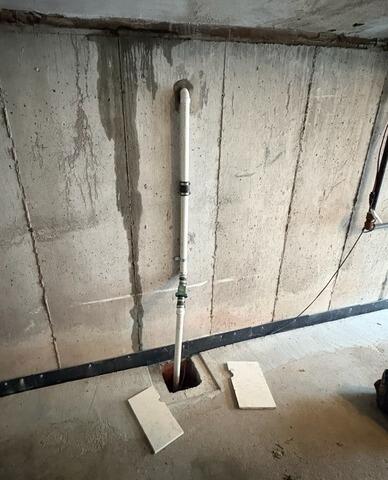 Sump Pump System Upgrade in a Boston, MA Garage - Before Photo