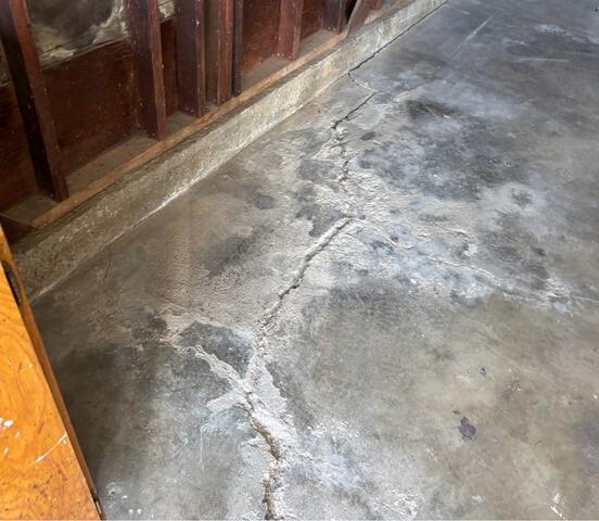 Concrete Leveling and Crack Sealant Restore Garage Floor in Poway, CA - Before Photo