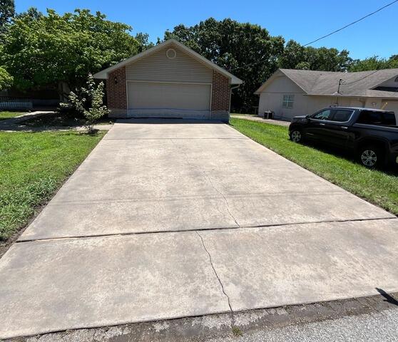 Concrete Driveway Lifted and Sealed with PolyLevel, NexusPro & DecoShield in Bella Vista, AR 72715 - Before Photo