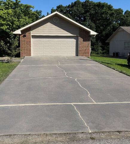 Concrete Driveway Lifted and Sealed with PolyLevel, NexusPro & DecoShield in Bella Vista, AR 72715 - After Photo