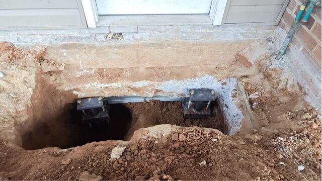 Sinking Entryway Slab Stabilized with Helical Piers in Advance, NC - Before Photo
