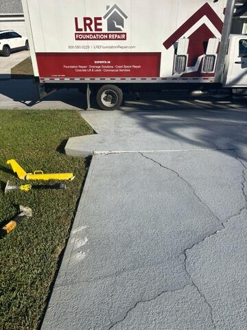 Leveling and Repairing Concrete Driveway in Palm Bay, FL - Before Photo