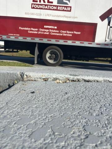 Concrete Driveway Slab Leveling in Palm Bay, FL - Before Photo