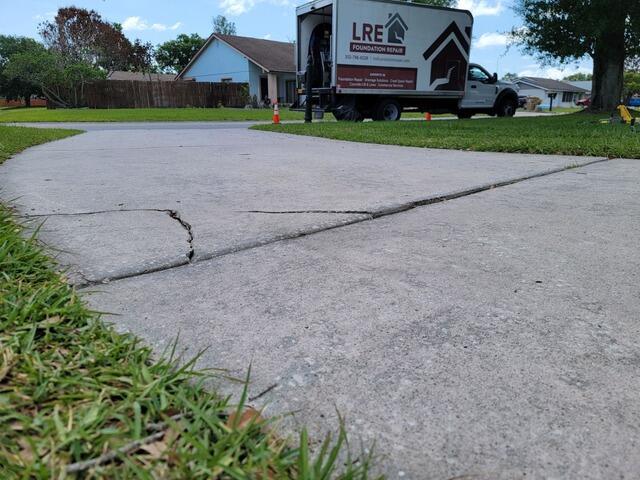 Leveling and Repairing Concrete Driveway in Kissimmee, FL - Before Photo